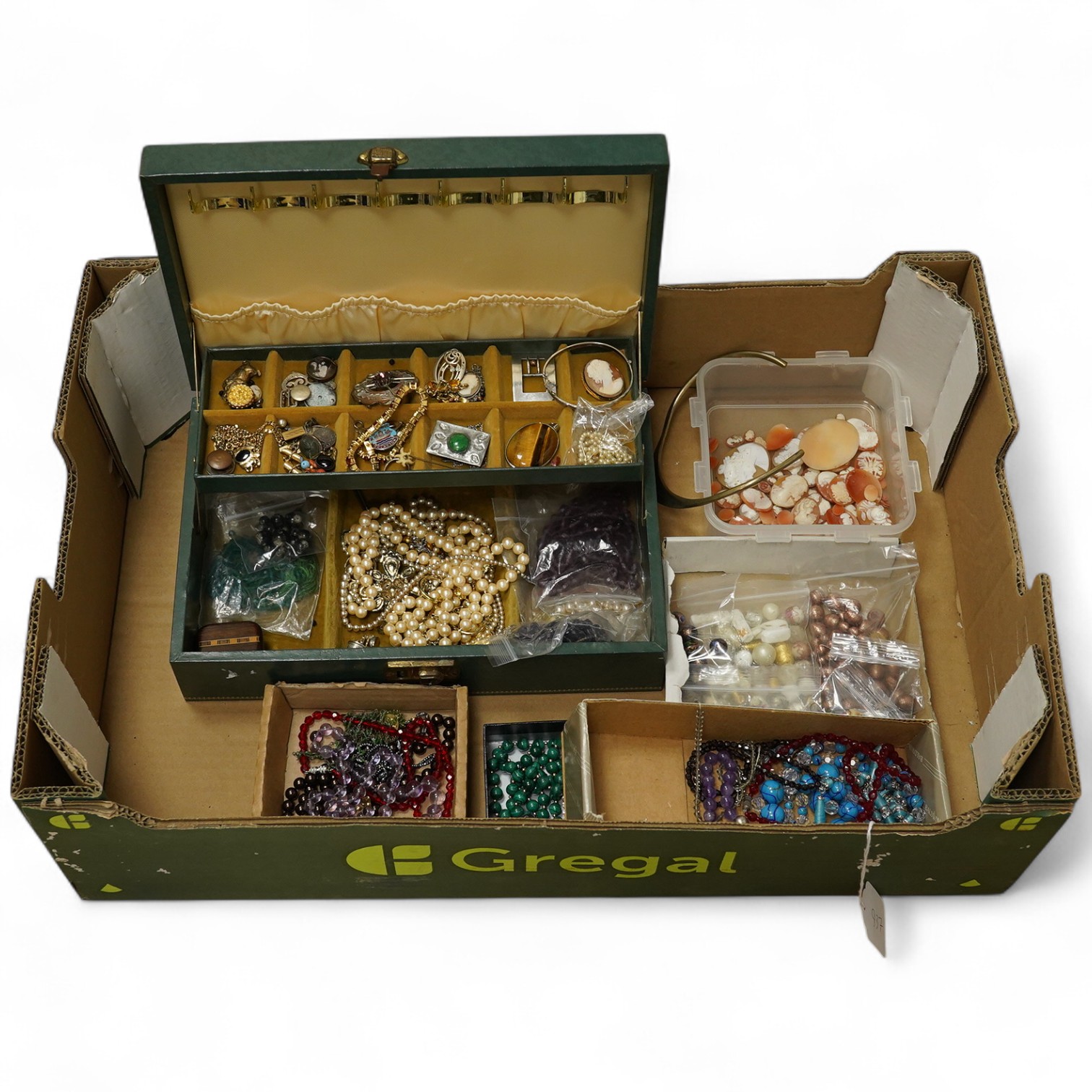 A quantity of assorted costume and and other jewellery including amethyst beads, malachite beads, tiger's eye quartz pendant, unmounted shell cameos, etc. Condition - poor to fair to good